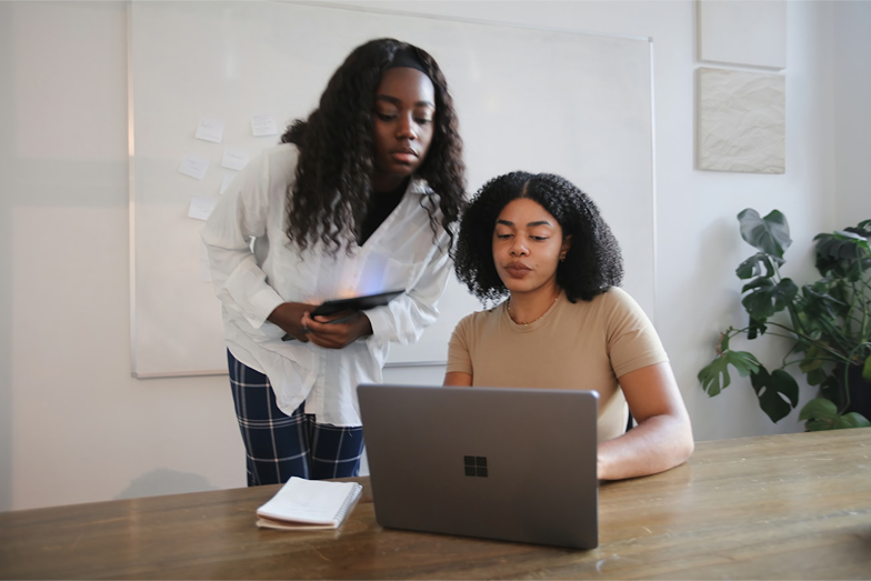 Two women looking at a laptop together